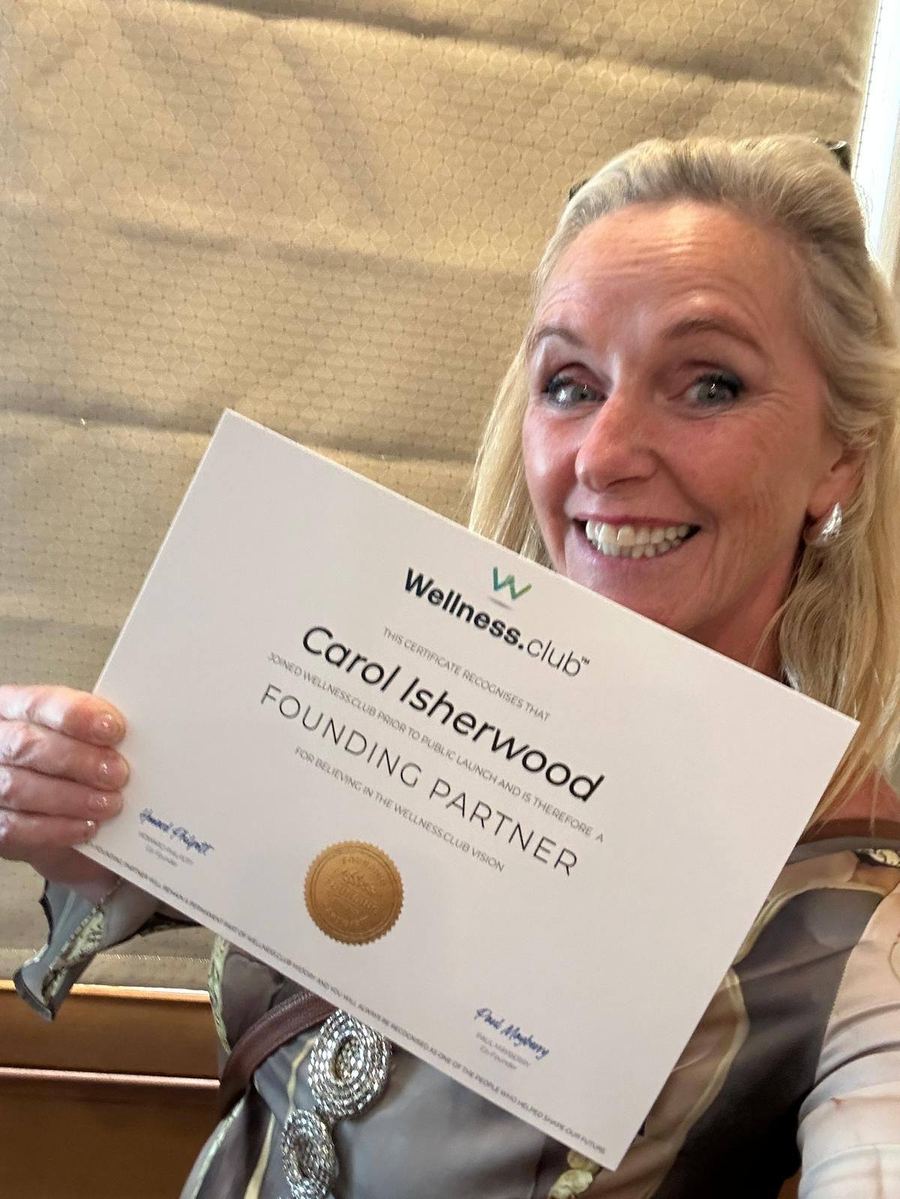 Carol Isherwood holding her wellness.club Founding Partner certificate, signed by Paul Mayberry